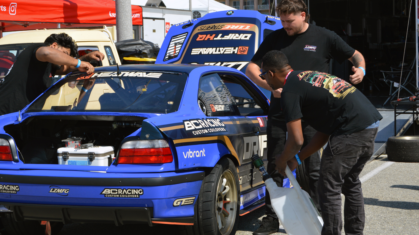 An image of a pit team working on a drift vehicle.