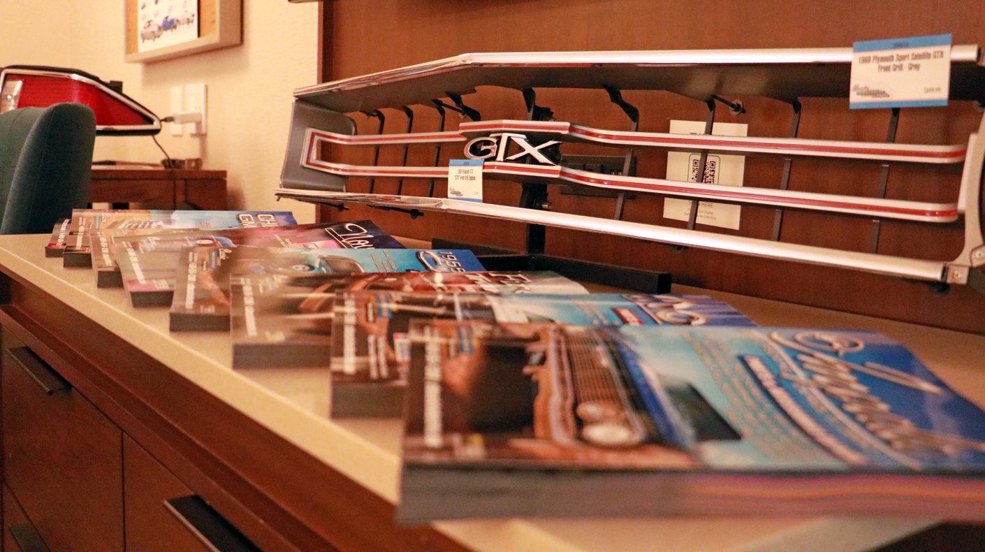 product catalogs on display next to an automotive grille at the 2026 MPMC Media Trade Conference