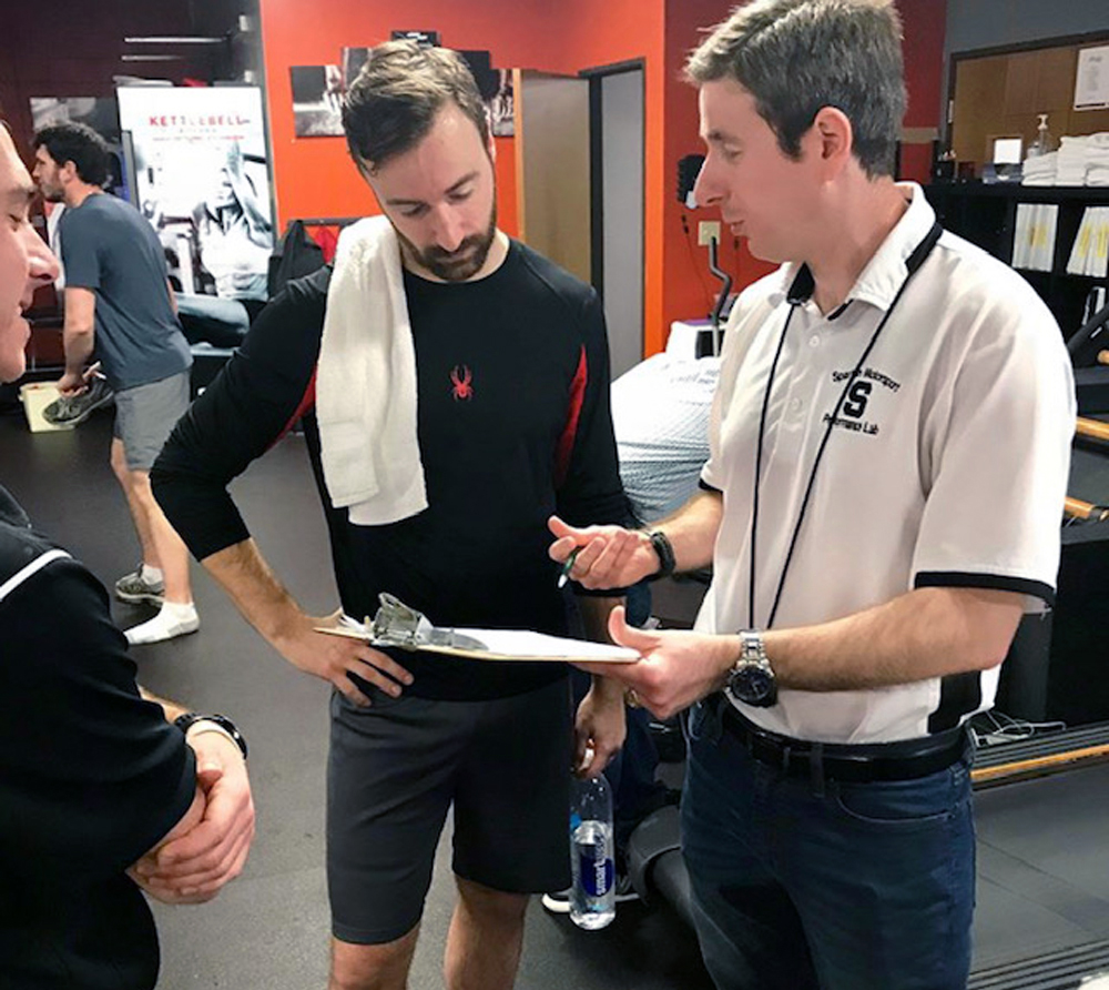Racers are increasingly turning to medical experts such as Dr. David Ferguson, pictured at right with IndyCar driver James Hinchcliffe, for insight into the physiological aspects of racing, which can be applied to improve performance, safety, and endurance.
