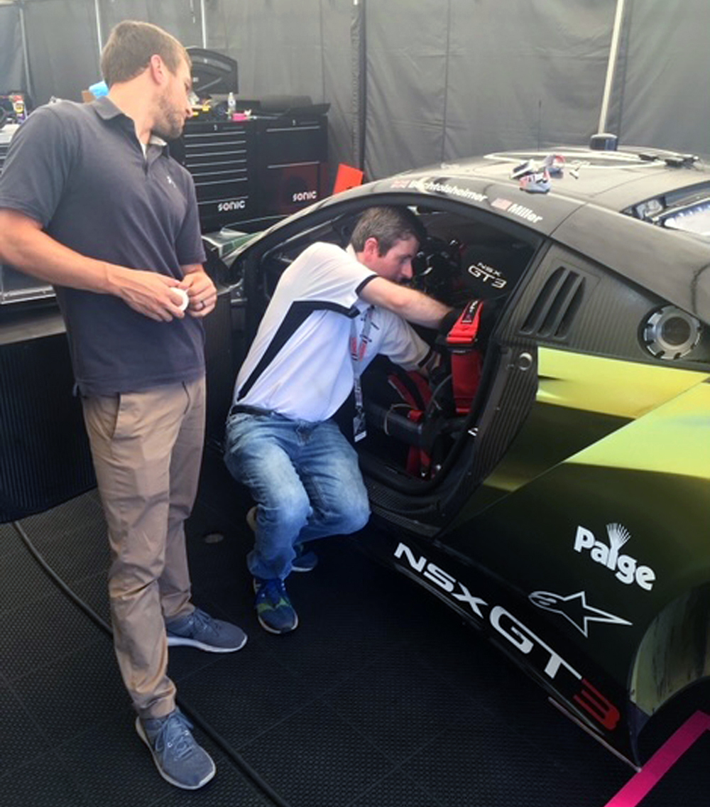 Modern race cars are loaded with sensors, making them well-suited for sports analytics. “For the first time, racing is actually leading the field,” observed Dr. David Ferguson, who is shown here collecting physiology data in a Gradient Racing Acura NSX.