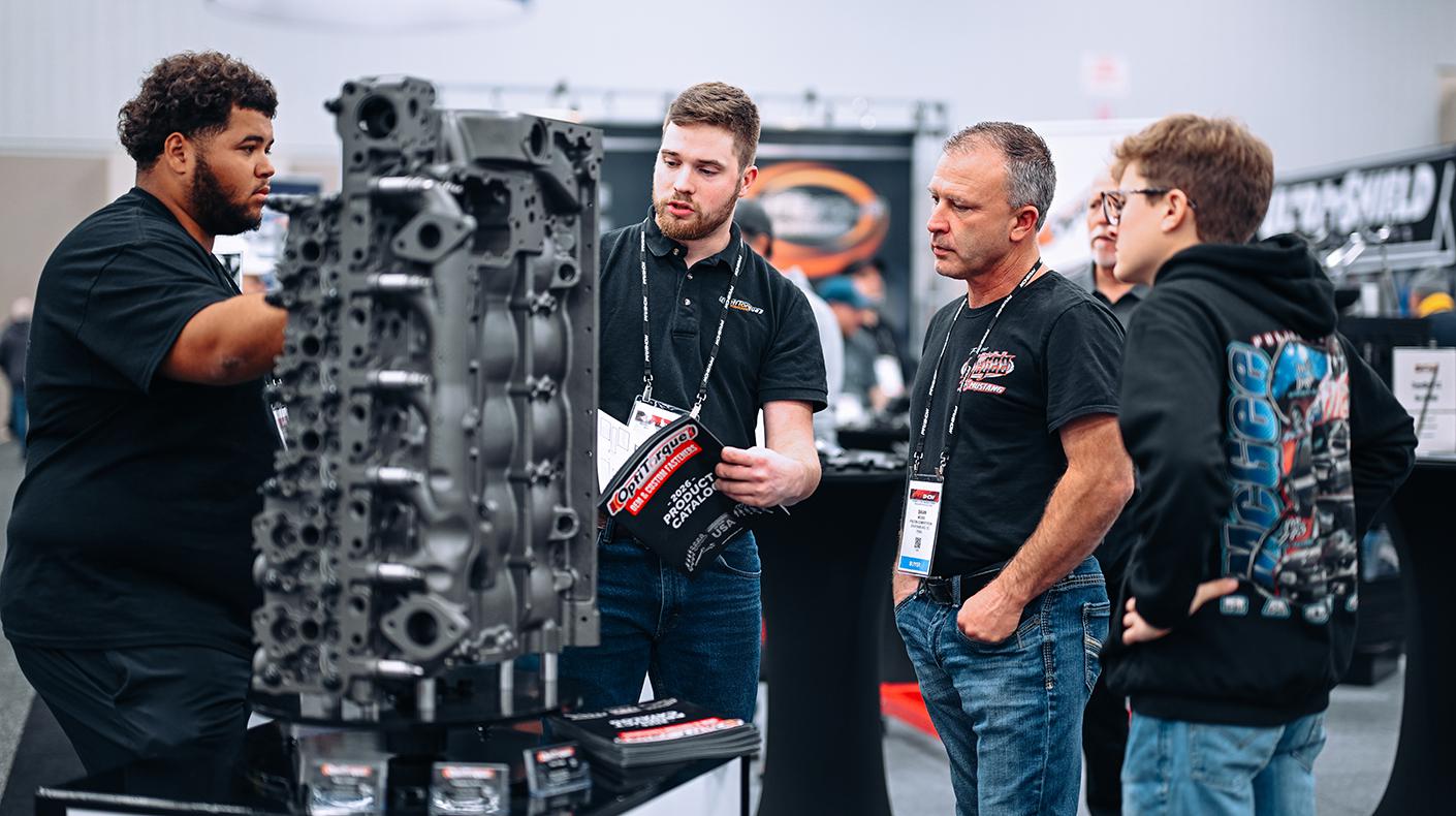 People in a booth at the PRI Show.