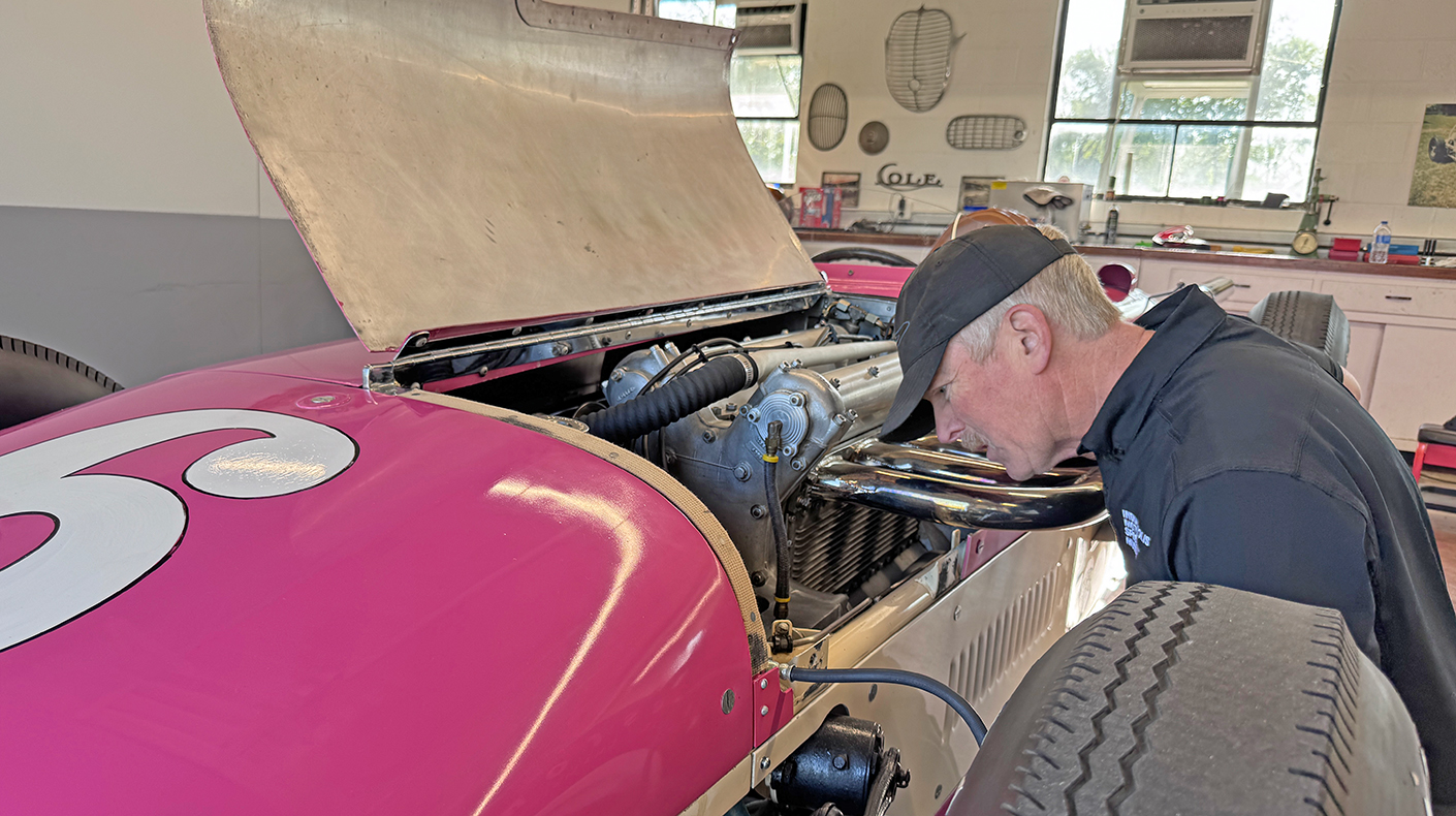 A mechanic working on a historic Indy car.