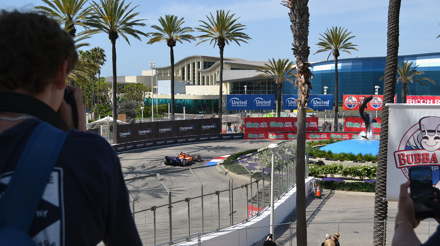 A fan taking photos at the Acura Grand Prix of Long Beach
