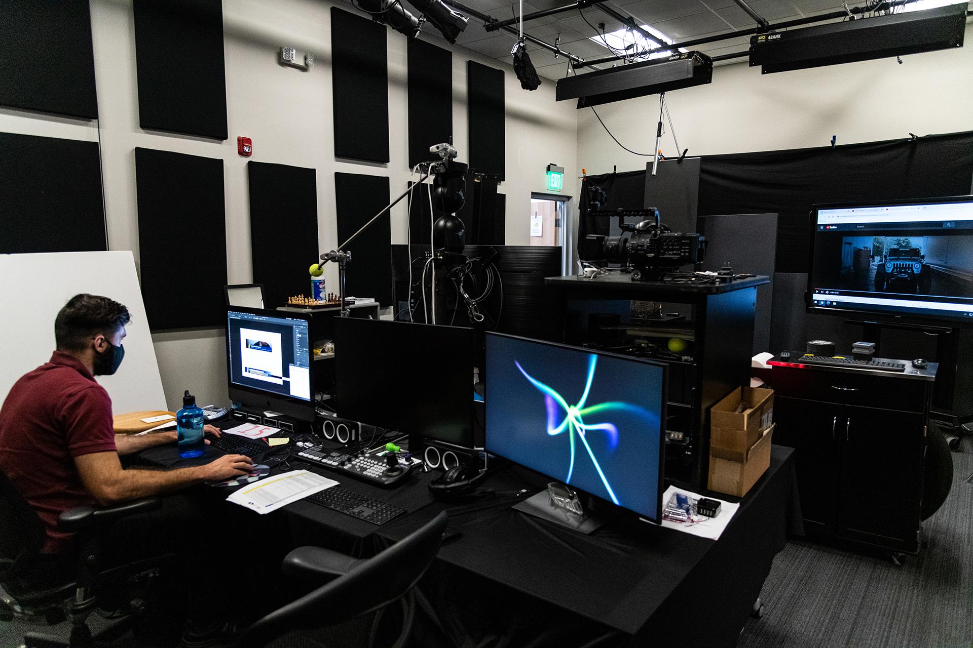 Man working at computer station inside Jackson Marketing headquarters in Santee, California