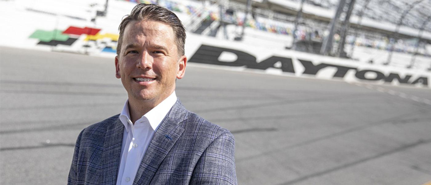 New Daytona International Speedway President Frank Kelleher standing on the race track. Photo courtesy of DIS