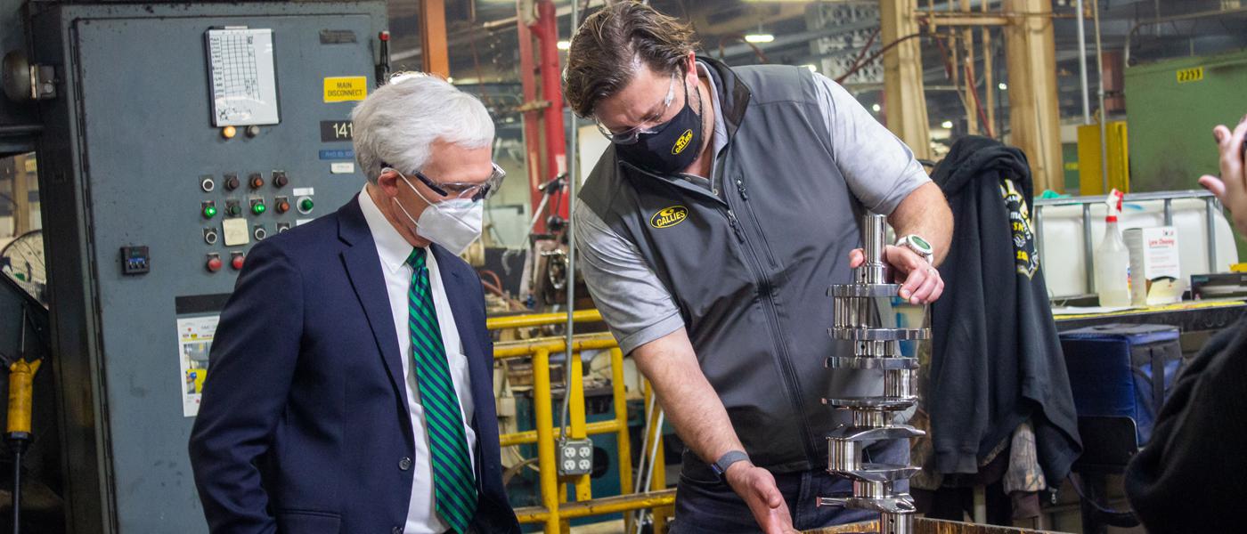 Heath Norton (right), Callies Performance Products vice president, displays a crankshaft to Rep. Bob Latta (R-OH)