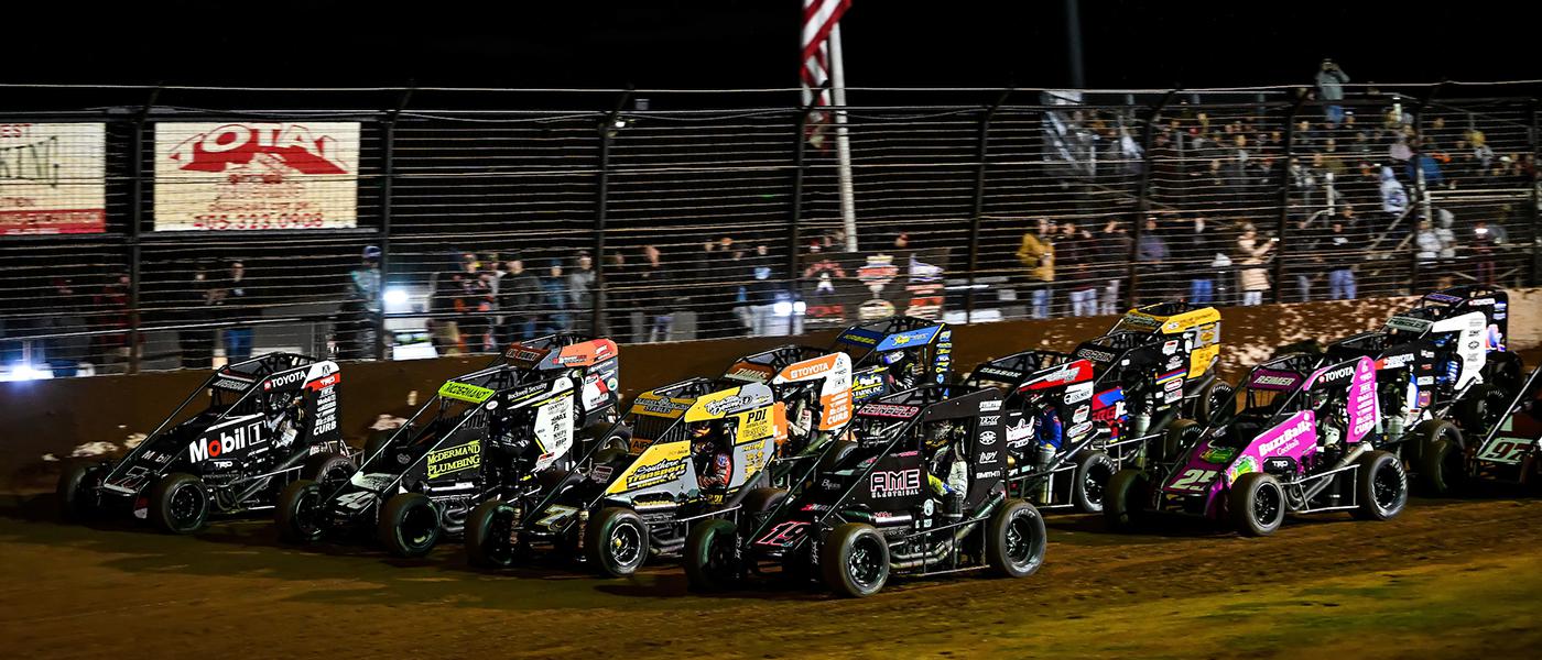 Midget cars line up for the start of a race
