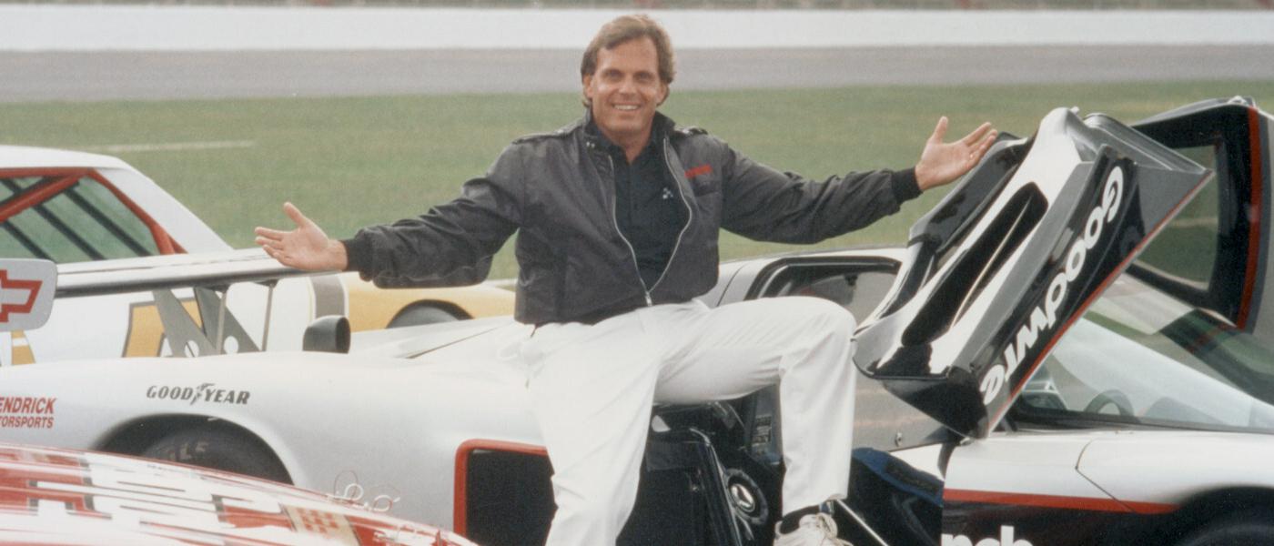 Young Rick Hendrick sitting on racecars