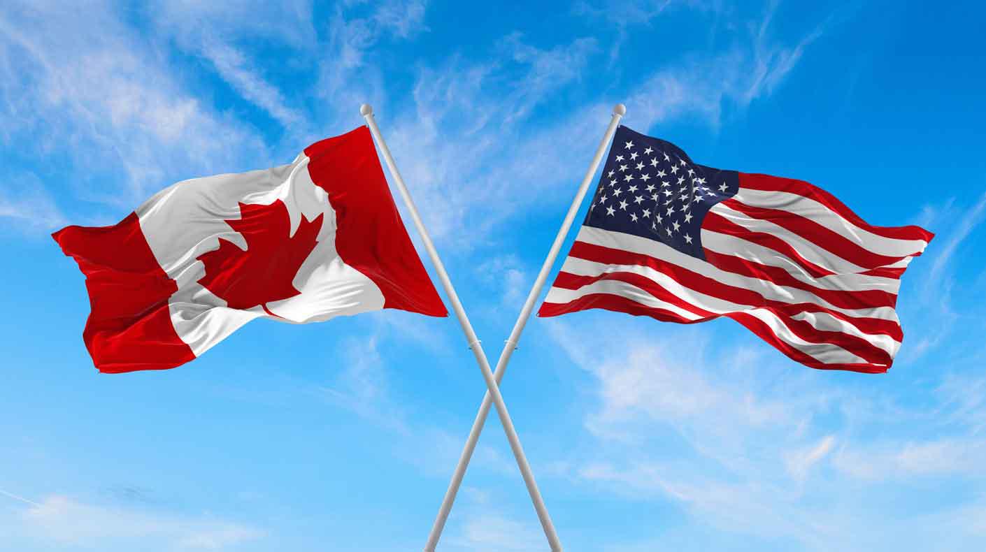 Canadian flag and US flag. Courtesy of Shutterstock