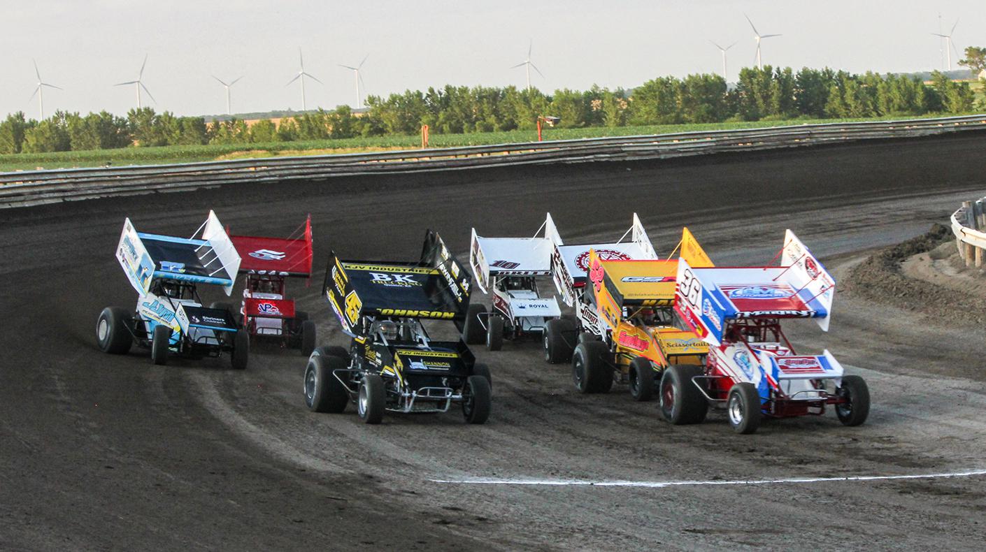 An image of winged Sprint Cars racing at Belleville Speedway in Kansas.