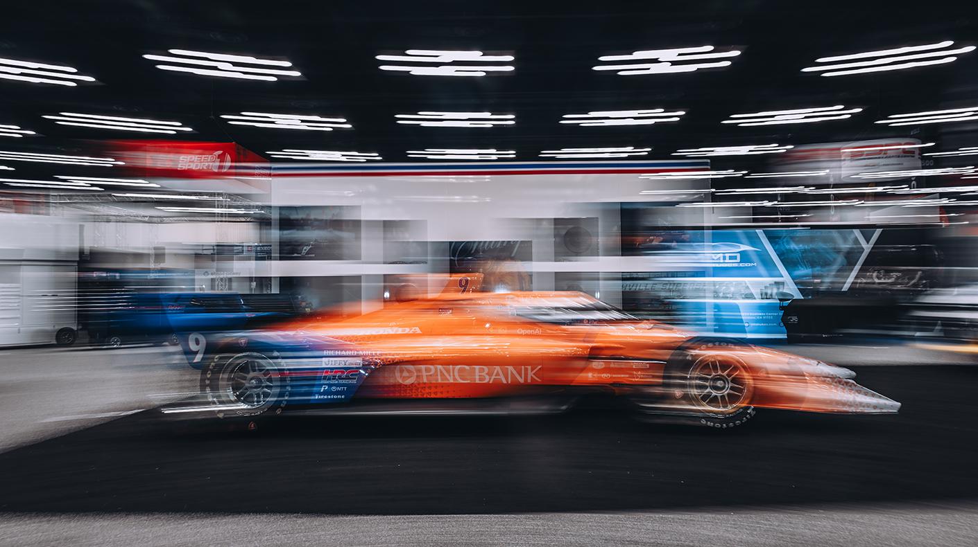 A blurry INDYCAR on the PRI Show floor.