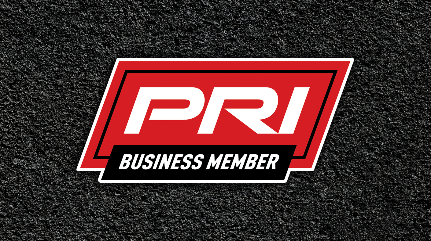 An image of the PRI Business Member logo overlaid asphalt background.