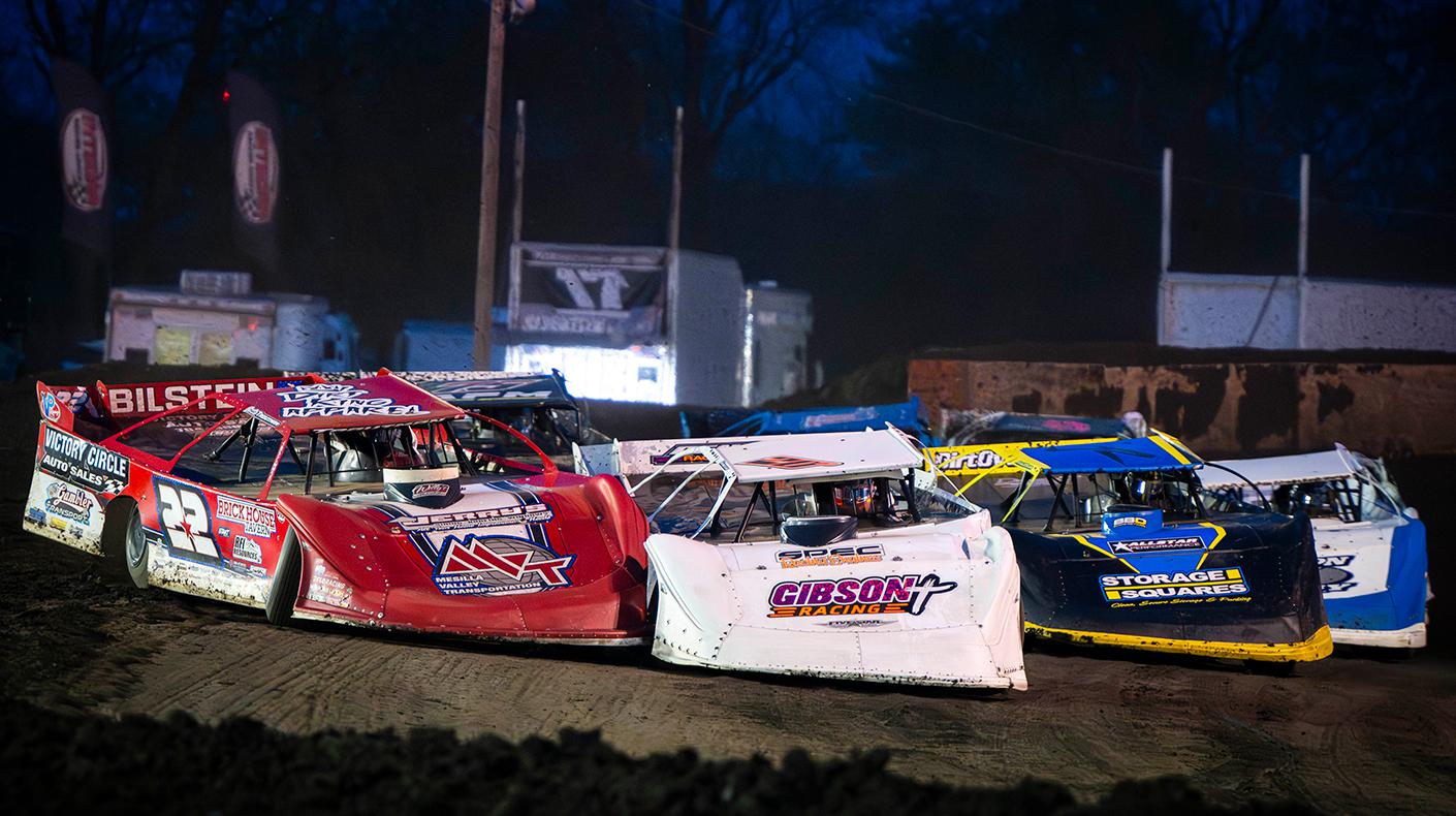 Dirt Late Models on a dirt track.