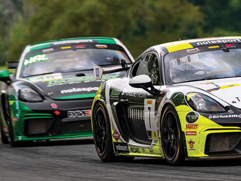 Porsche race cars on track