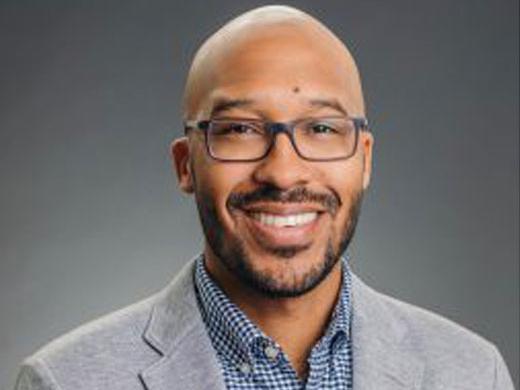 Headshot of Eric Ryan, and NASCAR logo