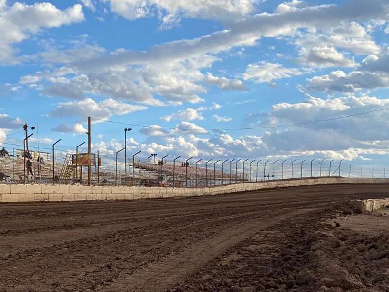 Photo of San Tan Ford’s Arizona Speedway dirt track and grandstands with a blue sky