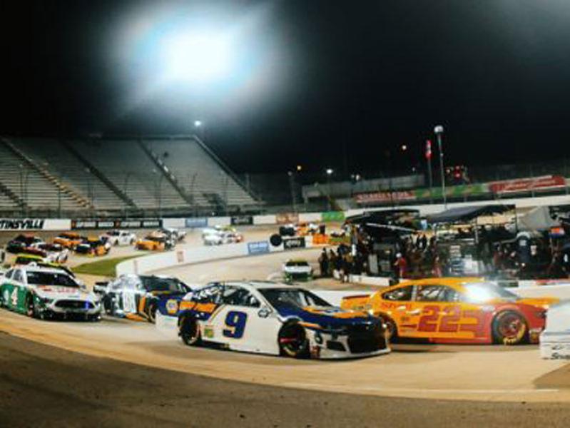 NASCAR race cars turning a corner at Martinsville Speedway