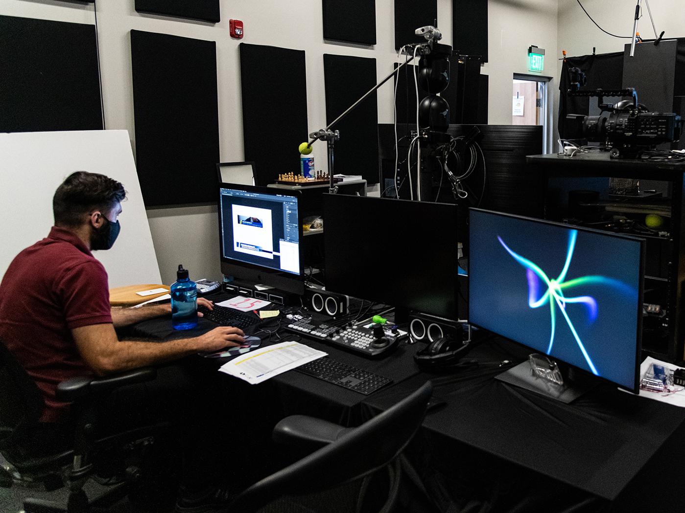 Man working at computer station inside Jackson Marketing headquarters in Santee, California