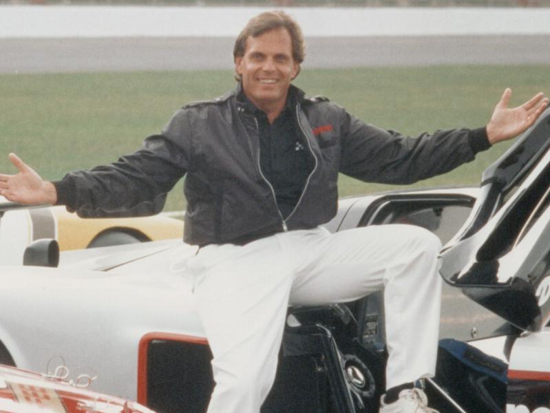 Young Rick Hendrick sitting on racecars