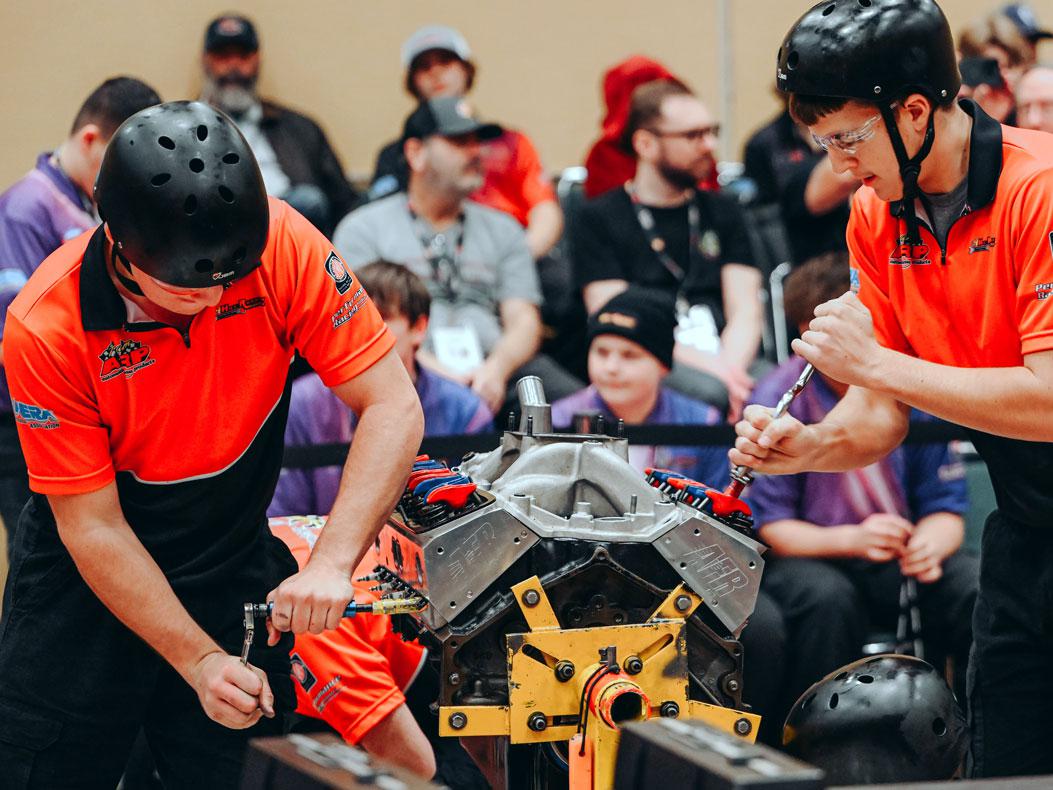 Hot Rodders of Tomorrow Returns to PRI Show in 2025. Image of 2024 high schoolers tearing down an engine for thecompetition