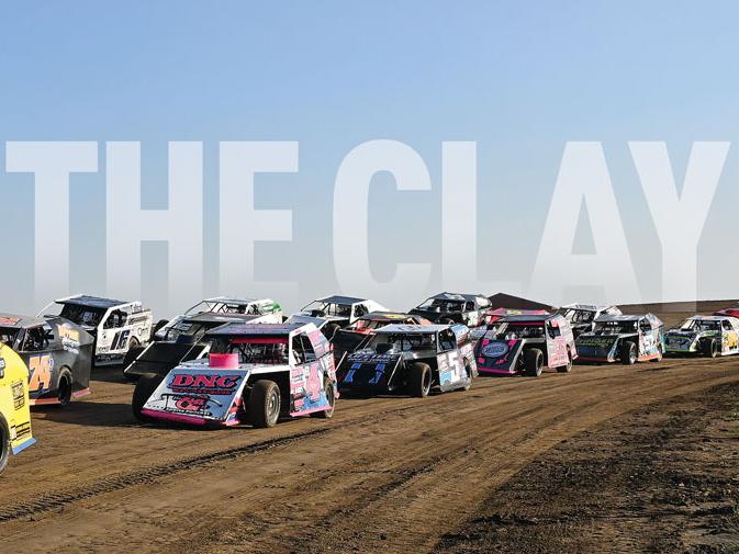 SHIFT ON THE CLAY text on top of full field of dirt modified vehicles