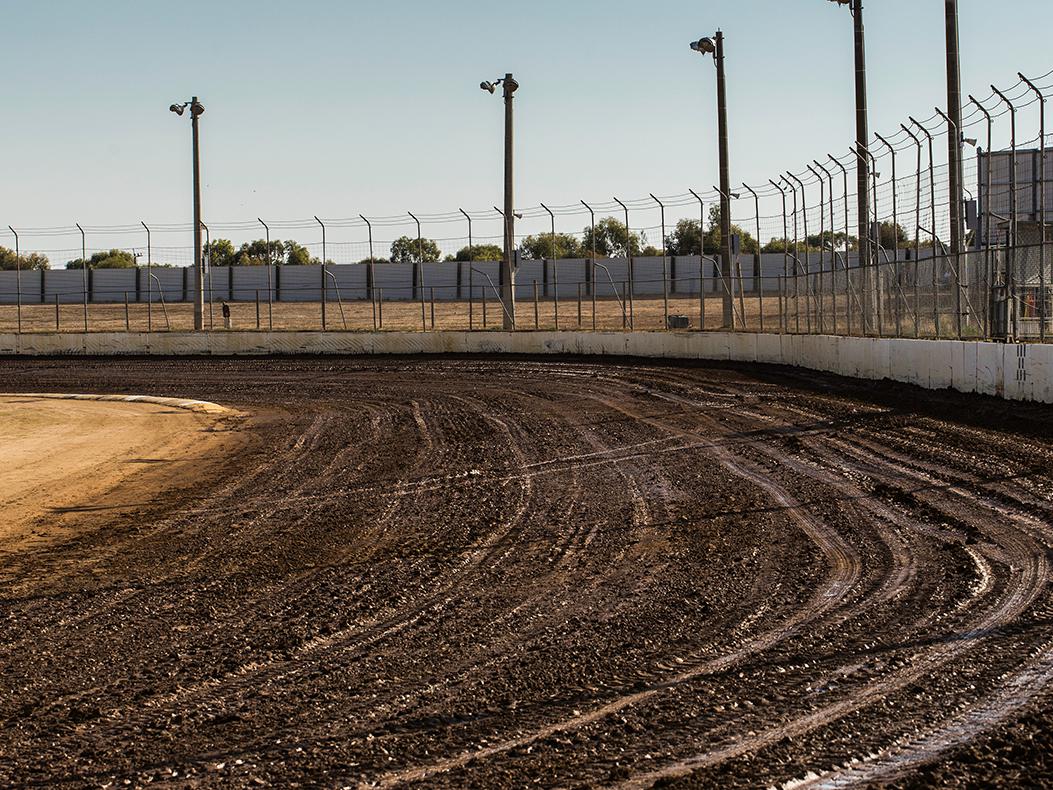 A dirt oval race track.