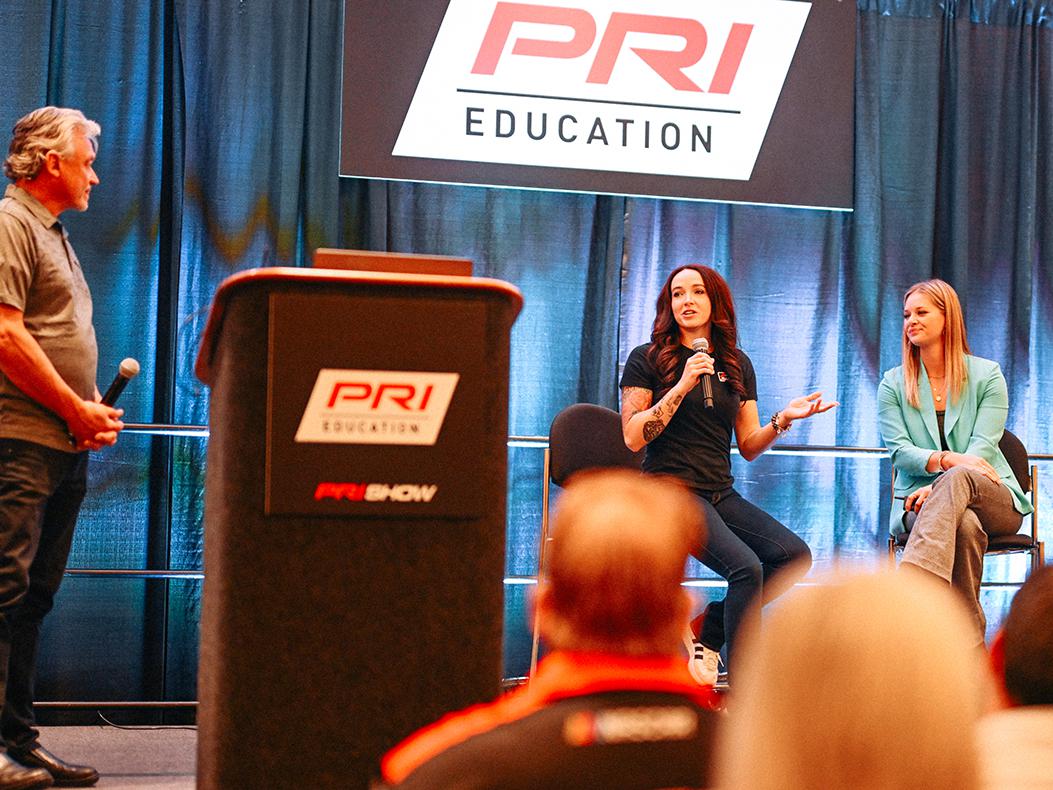 Panelists speaking during a PRI Education seminar.