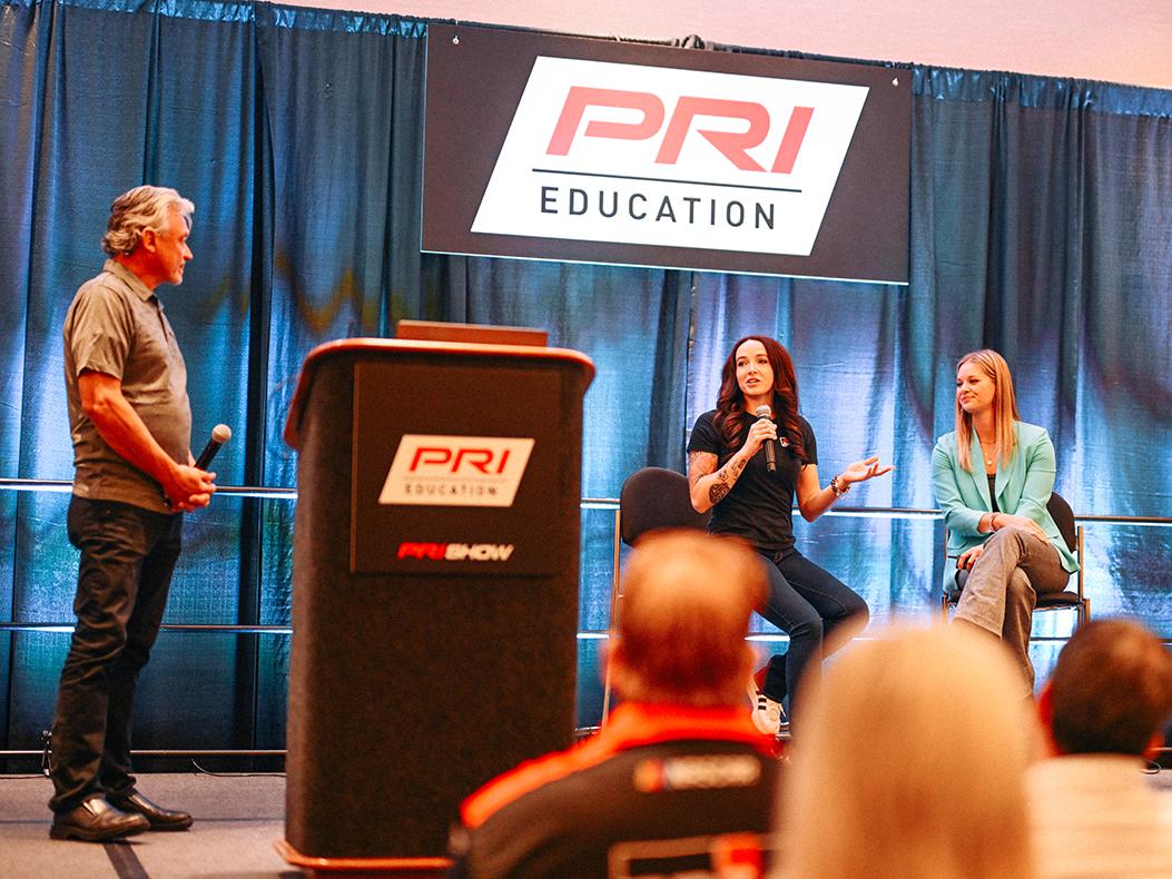 Presenters speaking during a PRI Education seminar.
